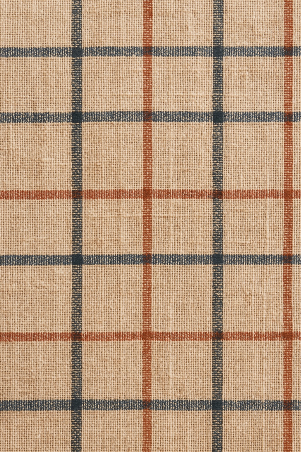 Close detail of a woven check textile in navy and rust on oatmeal cotton